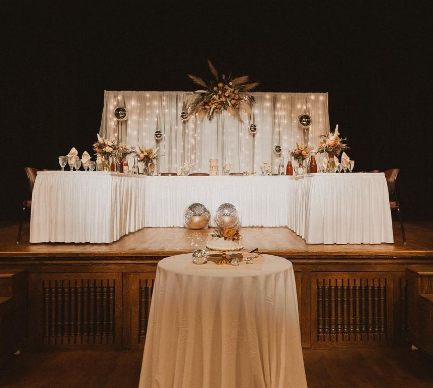 A head table decorated on the Durham Great Hall stage
