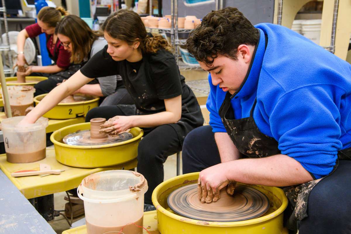 Customers using wheels to create pottery in The Workspace