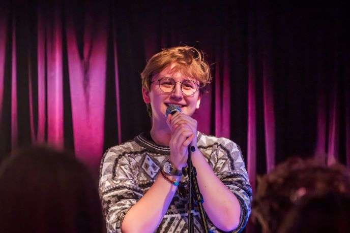 A student performs during open mic night